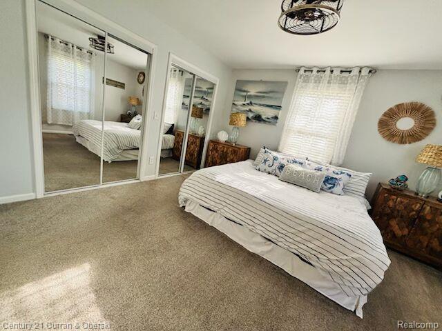 45215 Custer Ave, Utica, MI 48317 - bedroom featuring multiple closets, carpet, and baseboards