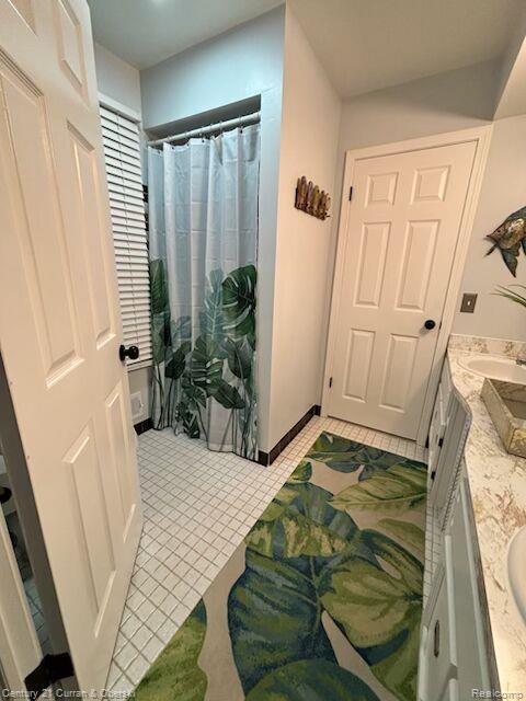 45215 Custer Ave, Utica, MI 48317 - full bathroom with vanity, tile patterned flooring, and curtained shower