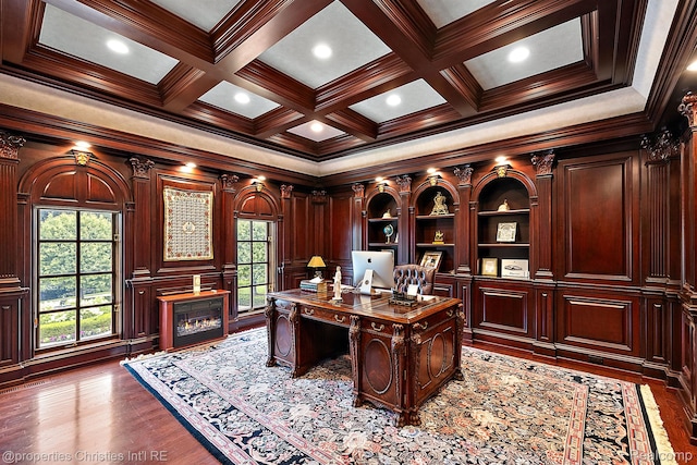 975 Sunningdale Dr, Bloomfield Hills, MI 48302 - home office with crown molding, a glass covered fireplace, beam ceiling, coffered ceiling, and dark wood-style flooring