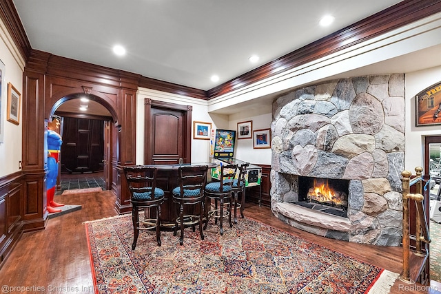 975 Sunningdale Dr, Bloomfield Hills, MI 48302 - dining space with ornamental molding, a dry bar, dark wood-type flooring, a fireplace, and a decorative wall