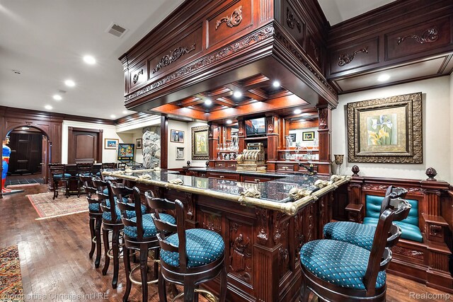 975 Sunningdale Dr, Bloomfield Hills, MI 48302 - indoor bar featuring arched walkways, ornamental molding, ornate columns, and dark wood-style flooring