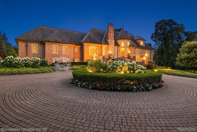 975 Sunningdale Dr, Bloomfield Hills, MI 48302 - french country home with a chimney, brick siding, and curved driveway