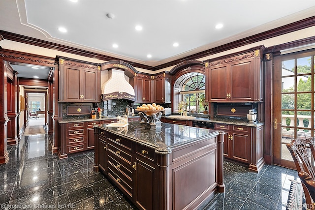 975 Sunningdale Dr, Bloomfield Hills, MI 48302 - kitchen featuring custom exhaust hood, ornamental molding, granite floors, dark stone counters, and a center island