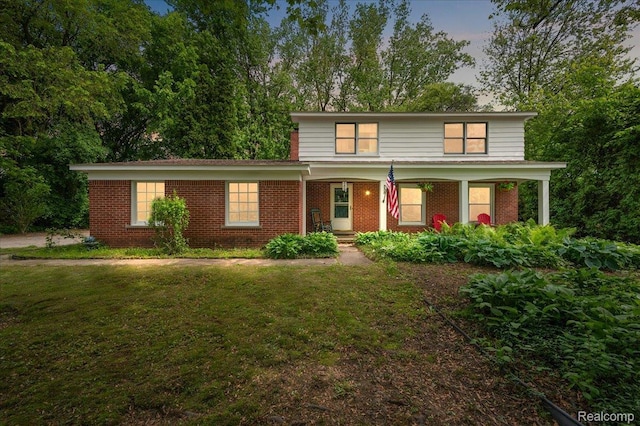 335 Douglas Dr, Bloomfield Hills, MI 48304 - traditional-style home featuring brick siding, a porch, and a front yard