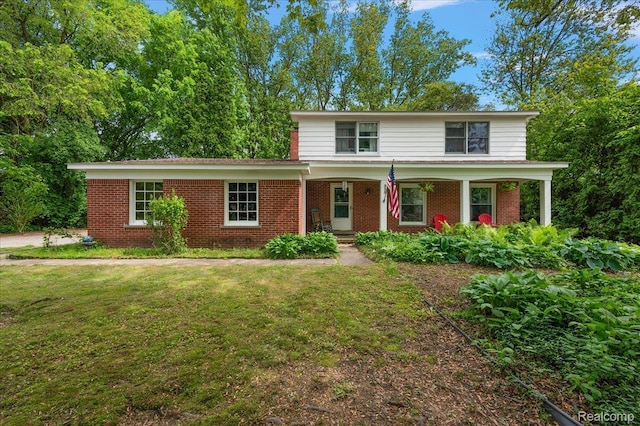 335 Douglas Dr, Bloomfield Hills, MI 48304 - traditional-style house with brick siding, a porch, and a front yard