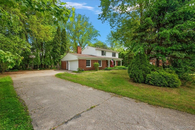 335 Douglas Dr, Bloomfield Hills, MI 48304 - traditional home featuring a chimney, asphalt driveway, brick siding, a front lawn, and an attached garage