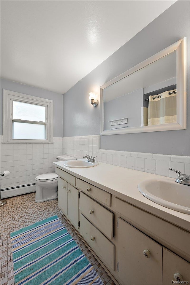 335 Douglas Dr, Bloomfield Hills, MI 48304 - full bath featuring a baseboard radiator, tile walls, double vanity, toilet, and a wainscoted wall