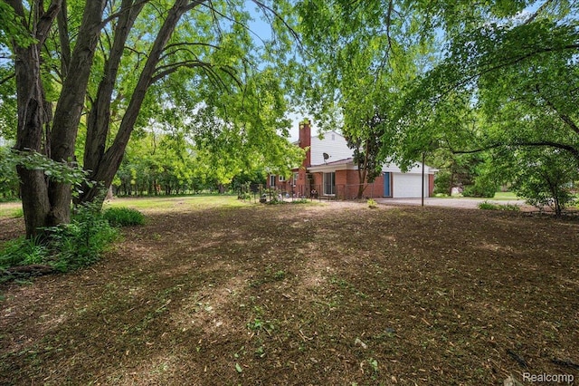 335 Douglas Dr, Bloomfield Hills, MI 48304 - view of yard with driveway and a garage