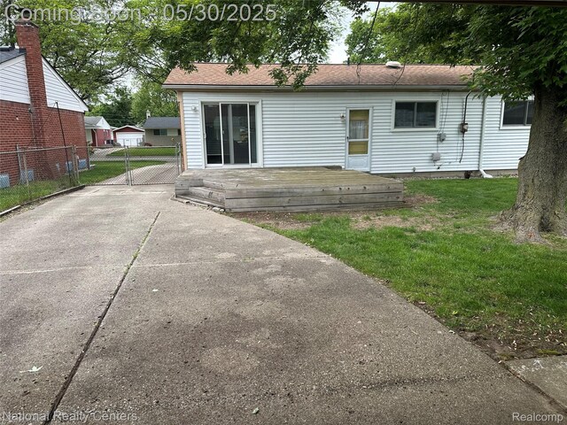 35951 Dover St, Livonia, MI 48150 - back of house featuring a wooden deck and concrete driveway