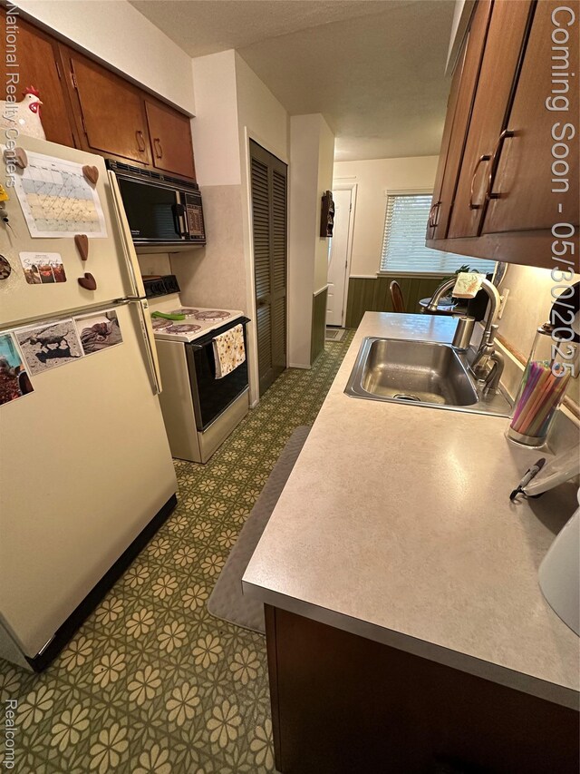 35951 Dover St, Livonia, MI 48150 - kitchen with white appliances, a sink, dark floors, and light countertops