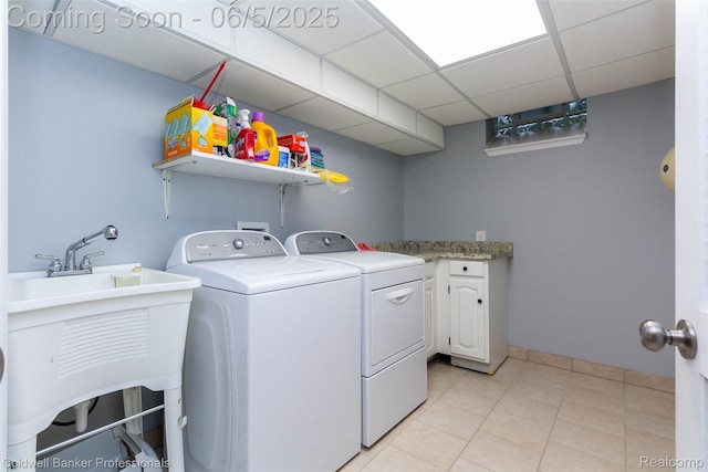 1975 Chancery Dr, Troy, MI 48085 - laundry room featuring washing machine and clothes dryer, light tile patterned floors, and cabinet space