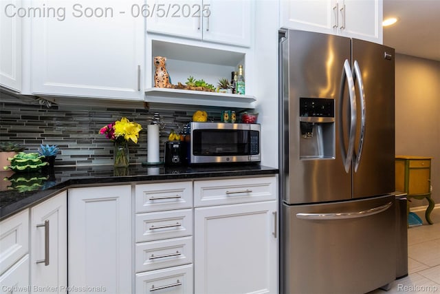 1975 Chancery Dr, Troy, MI 48085 - kitchen featuring appliances with stainless steel finishes, white cabinetry, tasteful backsplash, and dark stone counters