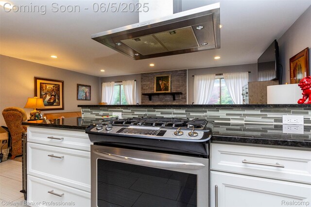 1975 Chancery Dr, Troy, MI 48085 - kitchen featuring stainless steel gas stove, extractor fan, decorative backsplash, recessed lighting, and white cabinetry
