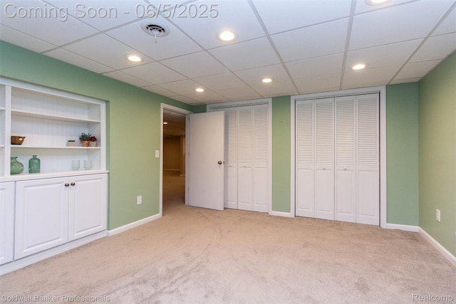 1975 Chancery Dr, Troy, MI 48085 - unfurnished bedroom with light colored carpet, two closets, baseboards, recessed lighting, and a paneled ceiling