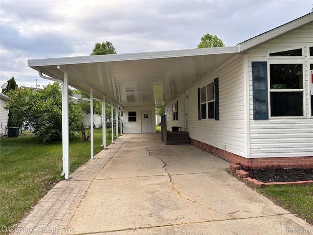 504 Bush Lake Ln, Smiths Creek, MI 48074 - view of patio featuring driveway, an attached carport, and central AC