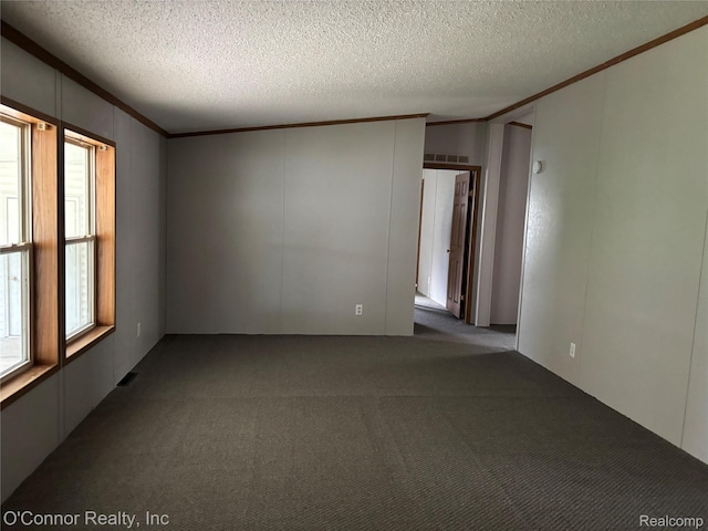 504 Bush Lake Ln, Smiths Creek, MI 48074 - empty room featuring ornamental molding, dark colored carpet, and a textured ceiling