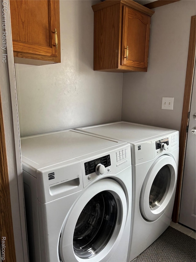504 Bush Lake Ln, Smiths Creek, MI 48074 - laundry area featuring cabinet space and washer and dryer