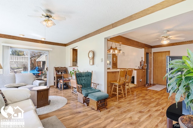 15179 Norman St, Livonia, MI 48154 - living area featuring ceiling fan, light wood-style floors, and a textured ceiling