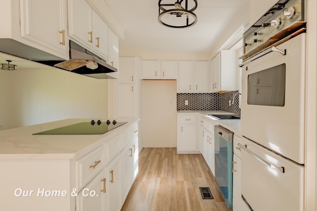 838 S Grey Rd, Midland, MI 48640 - kitchen with a sink, black electric stovetop, stainless steel dishwasher, light wood-type flooring, and backsplash