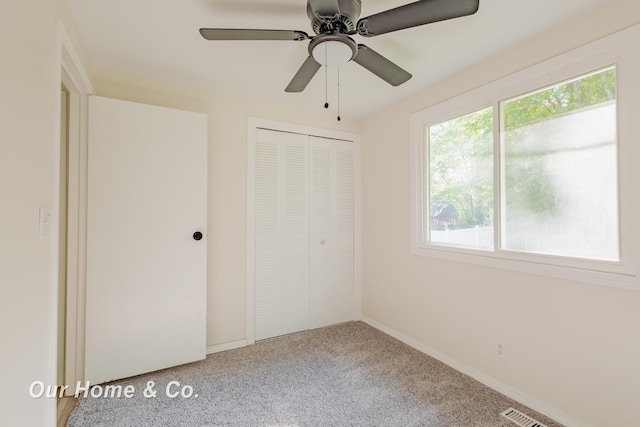 838 S Grey Rd, Midland, MI 48640 - unfurnished bedroom featuring carpet flooring, a closet, baseboards, and ceiling fan