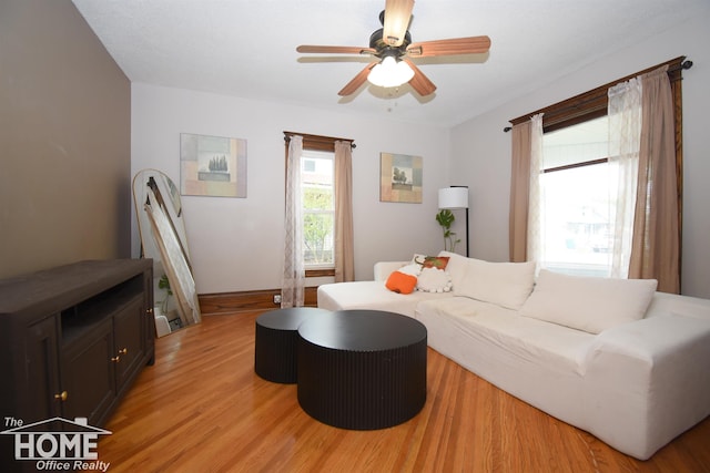 231 W Ridge St, Owosso, MI 48867 - living area with light wood-type flooring, ceiling fan, and baseboards