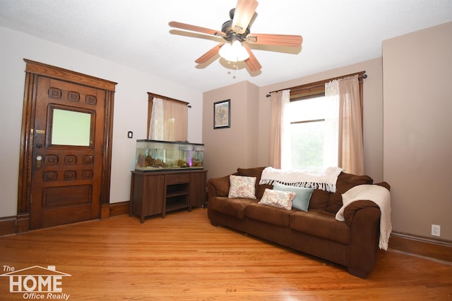 231 W Ridge St, Owosso, MI 48867 - living area with light wood finished floors, ceiling fan, and baseboards