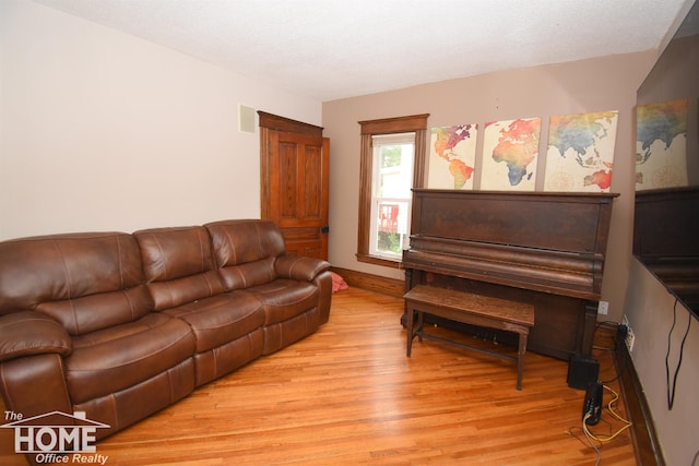 231 W Ridge St, Owosso, MI 48867 - living room with light wood-style floors