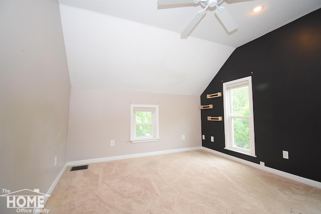 231 W Ridge St, Owosso, MI 48867 - additional living space with lofted ceiling, healthy amount of natural light, carpet floors, a ceiling fan, and baseboards