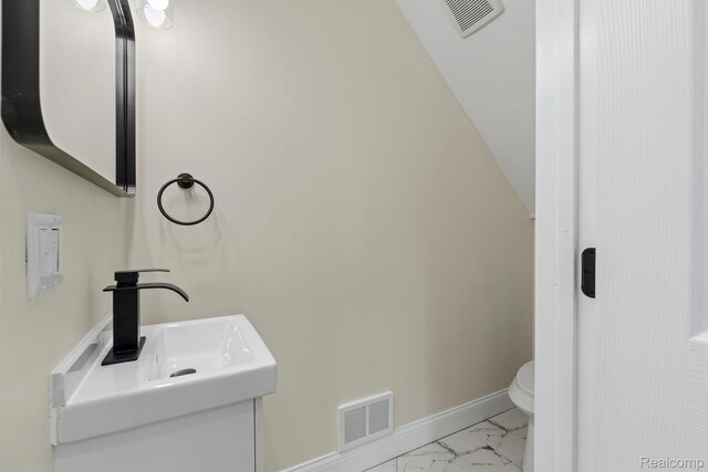 551 Englewood St, Detroit, MI 48202 - half bathroom with toilet, marble finish flooring, baseboards, and vanity