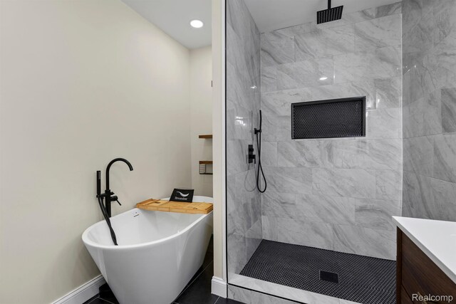 551 Englewood St, Detroit, MI 48202 - full bath with a freestanding tub, a tile shower, vanity, baseboards, and baseboard heating