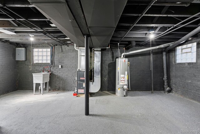 551 Englewood St, Detroit, MI 48202 - basement with gas water heater, heating unit, brick wall, and electric panel
