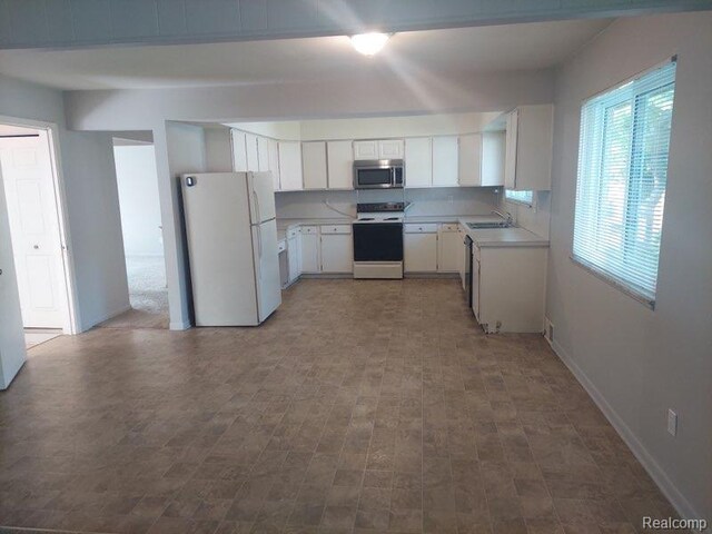 28601 Little Mack Ave, Saint Clair Shores, MI 48081 - kitchen with white appliances, a sink, light countertops, white cabinets, and baseboards
