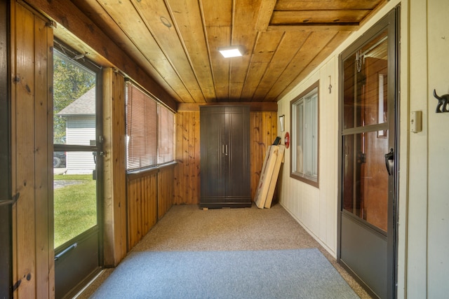 6132 W Houghton Lake Dr, Houghton Lake, MI 48629 - corridor with wooden ceiling, wooden walls, and light carpet