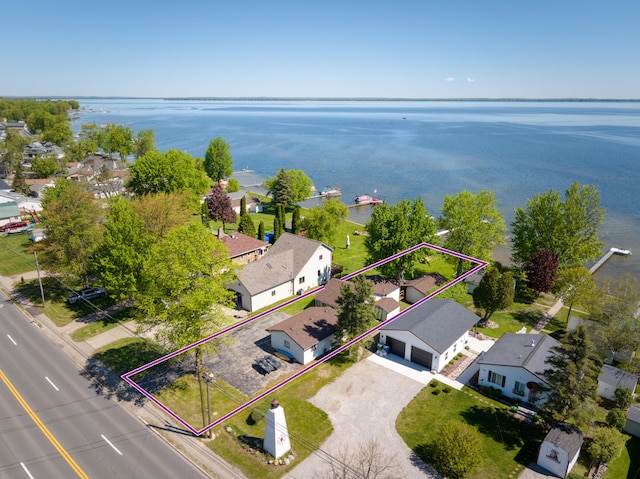 6132 W Houghton Lake Dr, Houghton Lake, MI 48629 - aerial view of residential area with property parcel outlined and a nearby body of water