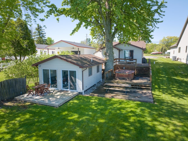 6132 W Houghton Lake Dr, Houghton Lake, MI 48629 - back of property featuring a hot tub and a deck