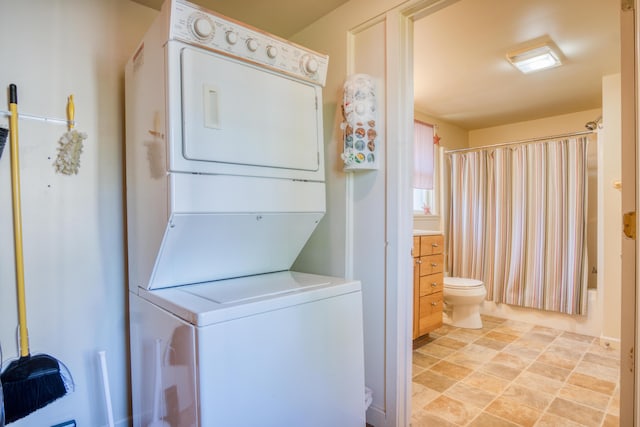 6132 W Houghton Lake Dr, Houghton Lake, MI 48629 - washroom featuring stacked washer / drying machine