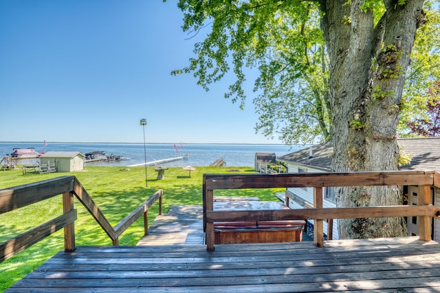 6132 W Houghton Lake Dr, Houghton Lake, MI 48629 - wooden terrace with a water view and a yard