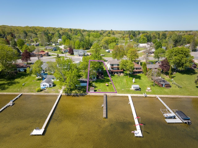 6132 W Houghton Lake Dr, Houghton Lake, MI 48629 - aerial perspective of suburban area with property boundaries highlighted and a nearby body of water