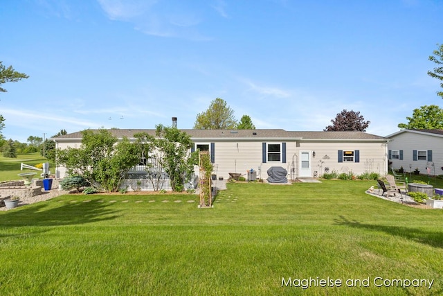 7560 Derbyboro Dr Unit 315, Caledonia, MI 49316 - view of front of house featuring a front yard and an outdoor fire pit