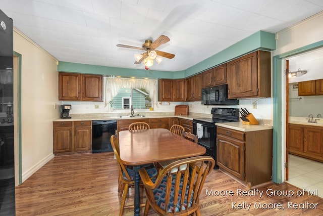 607 E Coffren St, Greenville, MI 48838 - kitchen with black appliances, a sink, a ceiling fan, and light countertops