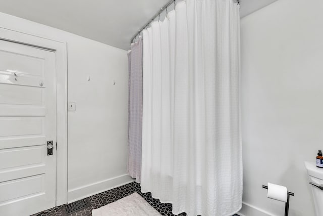 710 S 1st St, Ann Arbor, MI 48103 - bathroom with baseboards, tile patterned flooring, and toilet