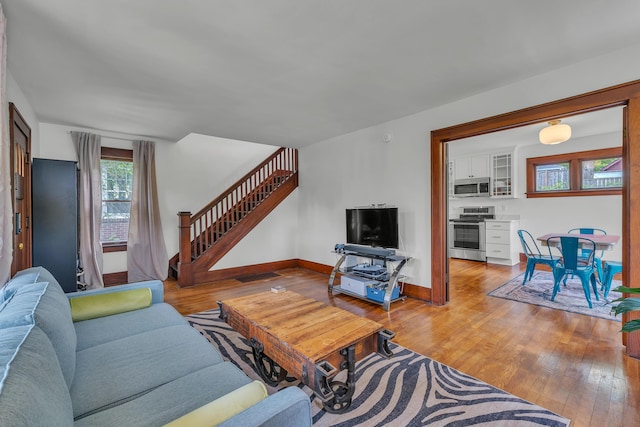 710 S 1st St, Ann Arbor, MI 48103 - living room featuring wood-type flooring, stairs, and baseboards