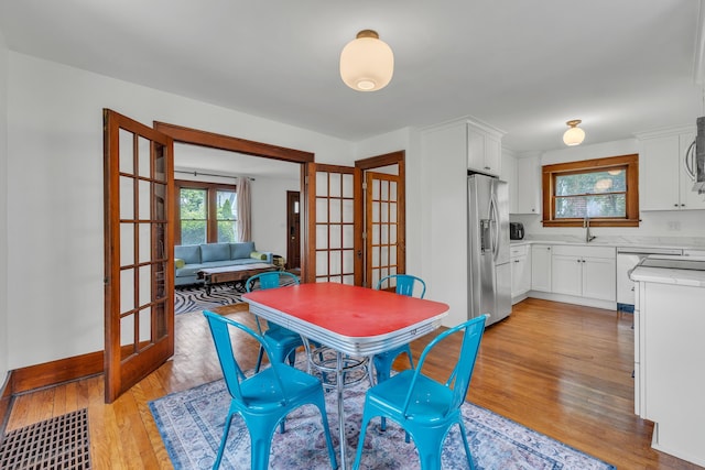 710 S 1st St, Ann Arbor, MI 48103 - dining area featuring french doors and light wood finished floors