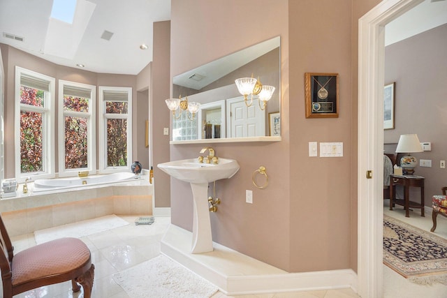 15919 Orchard Point Dr, Spring Lake, MI 49456 - full bathroom with a bath, tile patterned floors, a skylight, baseboards, and vaulted ceiling