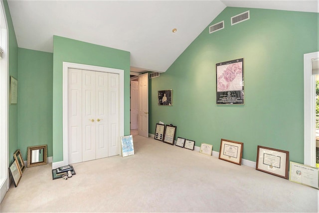 15919 Orchard Point Dr, Spring Lake, MI 49456 - carpeted bedroom with high vaulted ceiling, a closet, and baseboards