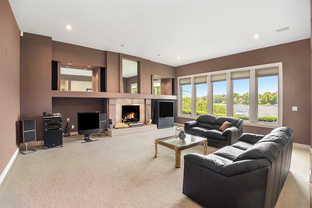 15919 Orchard Point Dr, Spring Lake, MI 49456 - carpeted living room featuring baseboards, a lit fireplace, and recessed lighting