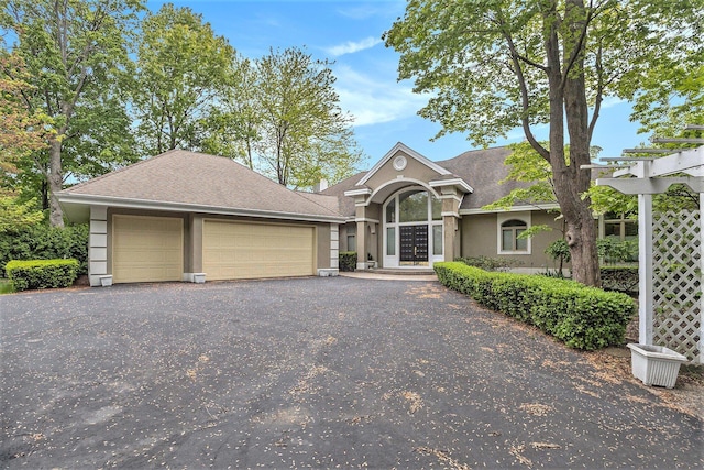 15919 Orchard Point Dr, Spring Lake, MI 49456 - view of front of property with stucco siding, a garage, french doors, roof with shingles, and asphalt driveway