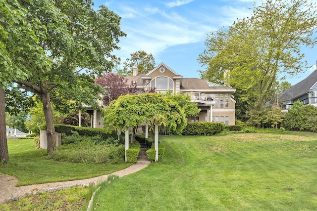 15919 Orchard Point Dr, Spring Lake, MI 49456 - view of front facade with a front lawn, stucco siding, and a chimney
