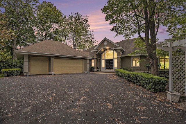 15919 Orchard Point Dr, Spring Lake, MI 49456 - view of front of house featuring a garage, asphalt driveway, and stucco siding