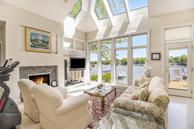 15919 Orchard Point Dr, Spring Lake, MI 49456 - tiled living area with a towering ceiling, a high end fireplace, and a skylight